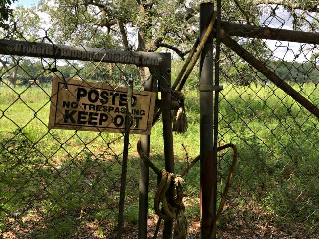 Keep Out sign on old chain link fence